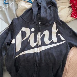 black zipper up with pink across the chest